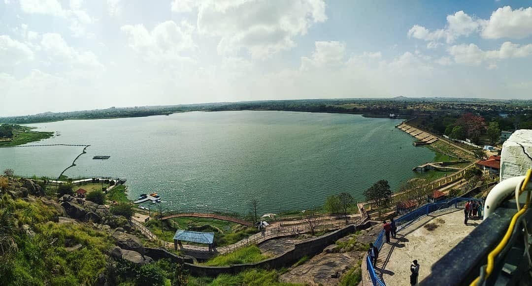 Kanke Dam reservoir at sunset — forested hills reflected in calm water, Ranchi, Jharkhand